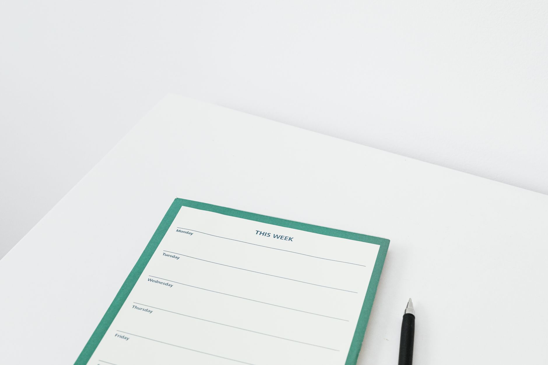 A one-page plan pinned beside a weekly calendar