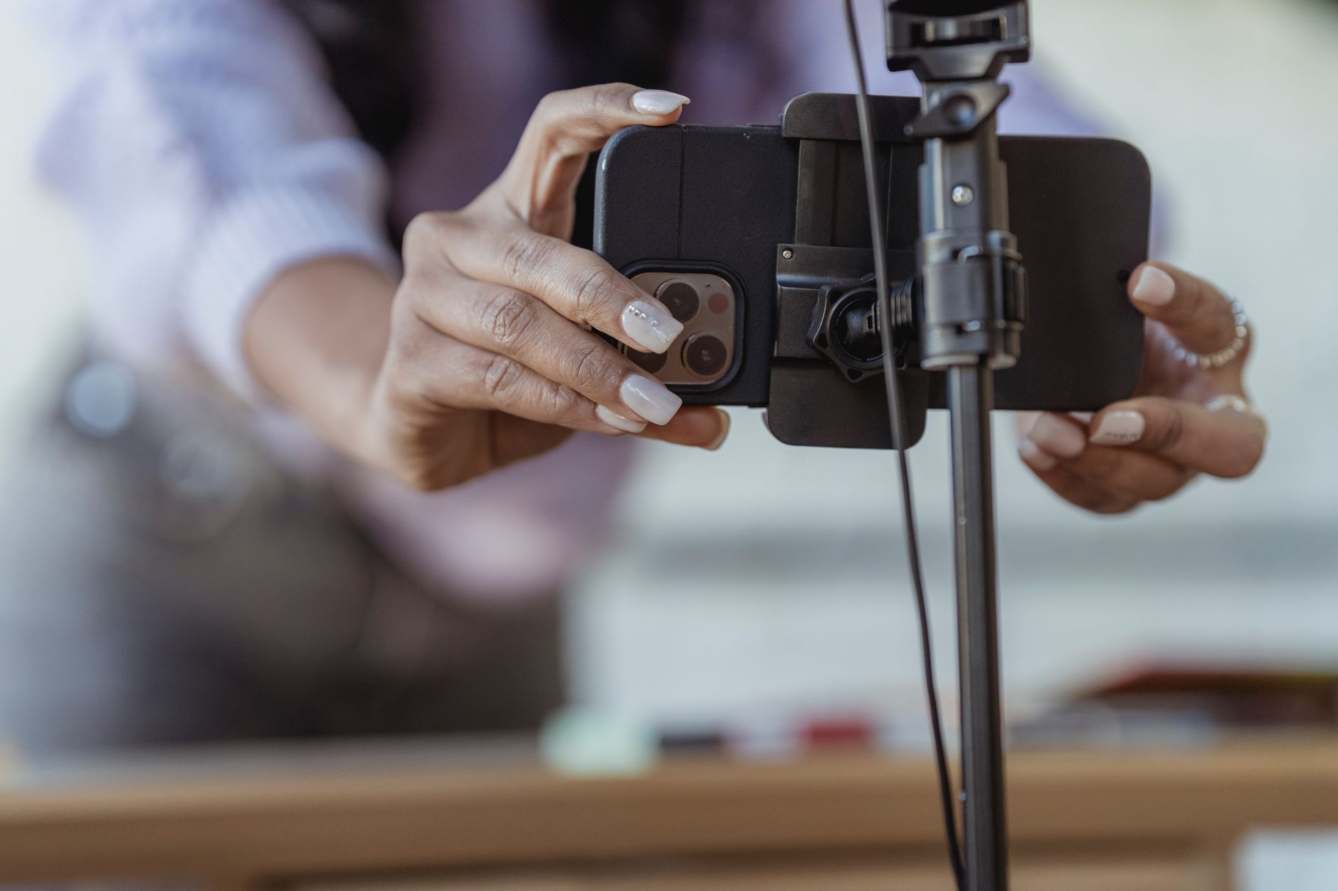 A phone on a tripod with teleprompter text near the lens